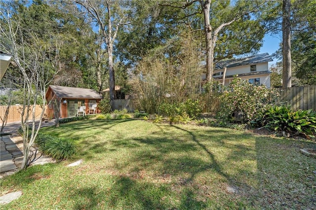 view of yard featuring a fenced backyard and an outbuilding