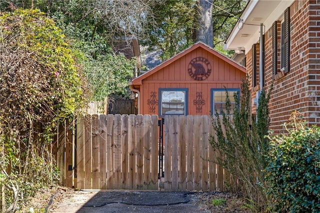 view of outbuilding featuring a gate and fence