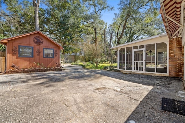 exterior space featuring a patio area and a sunroom