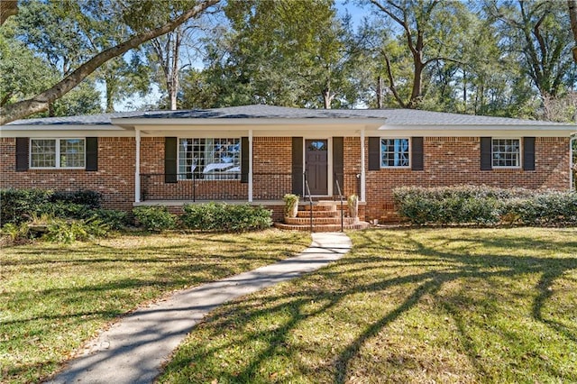 ranch-style home featuring brick siding and a front yard