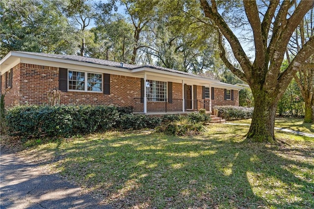 single story home with a front lawn and brick siding