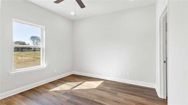 spare room featuring baseboards, a ceiling fan, wood finished floors, and recessed lighting