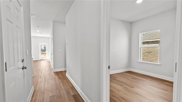 hall with recessed lighting, baseboards, and light wood-type flooring