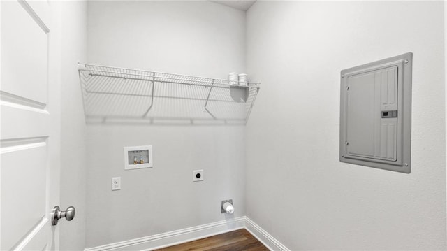 laundry area with laundry area, baseboards, hookup for a washing machine, electric panel, and hookup for an electric dryer