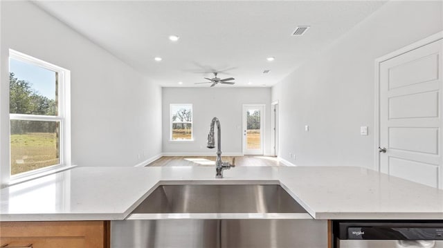 kitchen featuring a sink, recessed lighting, open floor plan, visible vents, and dishwashing machine