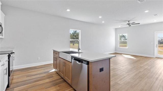 kitchen featuring ceiling fan, visible vents, a sink, stainless steel appliances, and a wealth of natural light