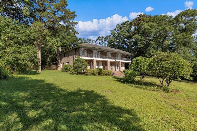608 Montclaire Way, Mobile, AL 36609 - back of house featuring a yard, brick siding, and a balcony