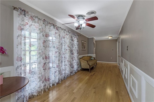 608 Montclaire Way, Mobile, AL 36609 - living area featuring ceiling fan, light wood-style flooring, crown molding, a decorative wall, and wainscoting