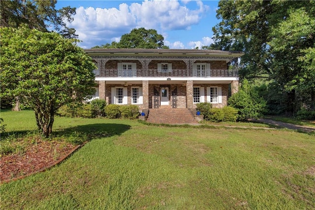 608 Montclaire Way, Mobile, AL 36609 - view of front of home featuring brick siding, a front lawn, a balcony, and french doors