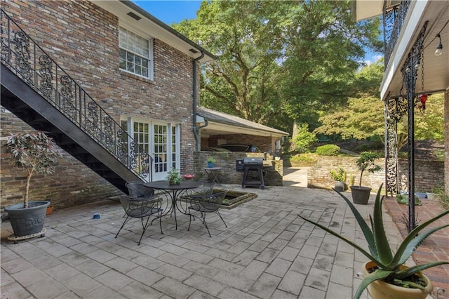608 Montclaire Way, Mobile, AL 36609 - view of patio / terrace with outdoor dining space, stairway, and a grill