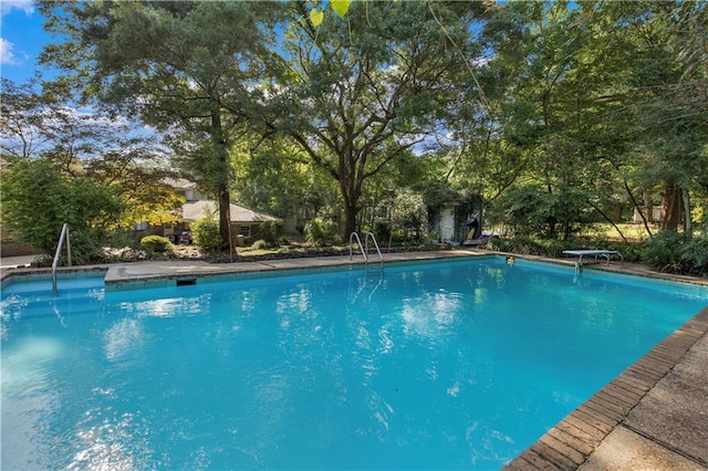 608 Montclaire Way, Mobile, AL 36609 - swimming pool with view of scattered trees and a diving board