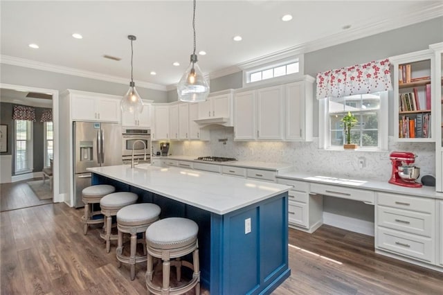 9102 Magnolia Ct, Spanish Fort, AL 36527 - kitchen with stainless steel fridge with ice dispenser, gas cooktop, white cabinetry, ornamental molding, and a breakfast bar