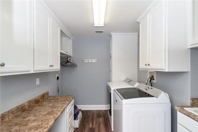 9102 Magnolia Ct, Spanish Fort, AL 36527 - laundry area featuring cabinet space, washing machine and dryer, baseboards, and dark wood-style flooring