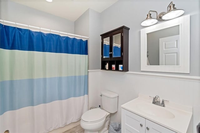 9102 Magnolia Ct, Spanish Fort, AL 36527 - bathroom with toilet, a wainscoted wall, vanity, and curtained shower
