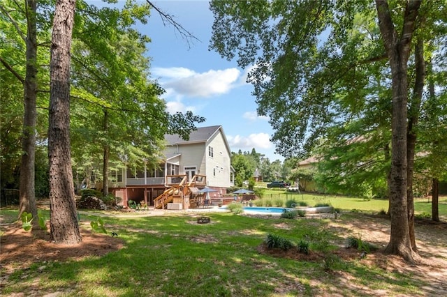 9102 Magnolia Ct, Spanish Fort, AL 36527 - view of green lawn with stairs, a wooden deck, an outdoor pool, and a sunroom