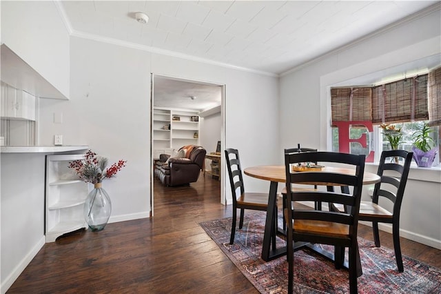 dining area featuring crown molding, wood finished floors, baseboards, and built in shelves