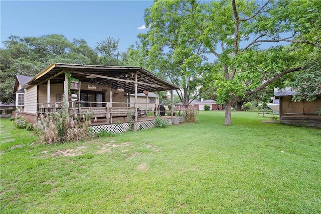 view of grassy yard featuring a wooden deck