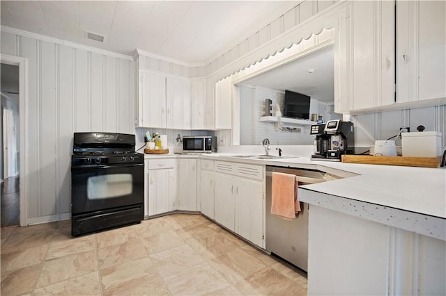 kitchen with appliances with stainless steel finishes, ornamental molding, light countertops, a sink, and white cabinets