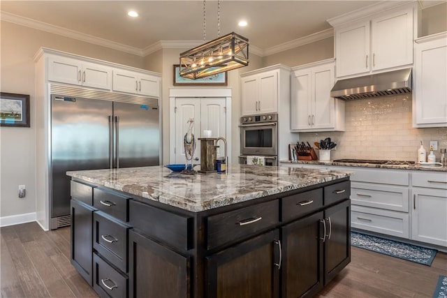 kitchen featuring under cabinet range hood, white cabinetry, appliances with stainless steel finishes, and crown molding