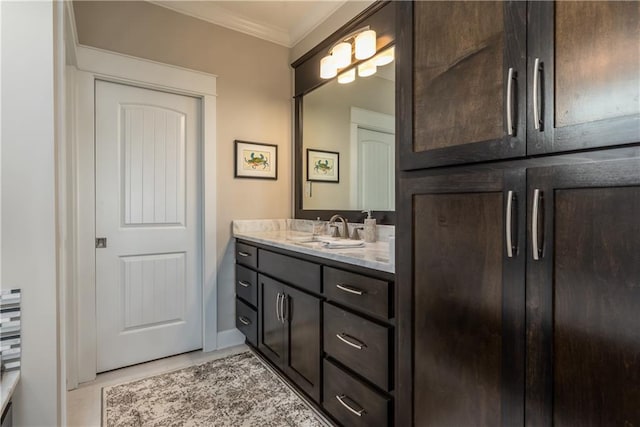 bathroom featuring ornamental molding and vanity