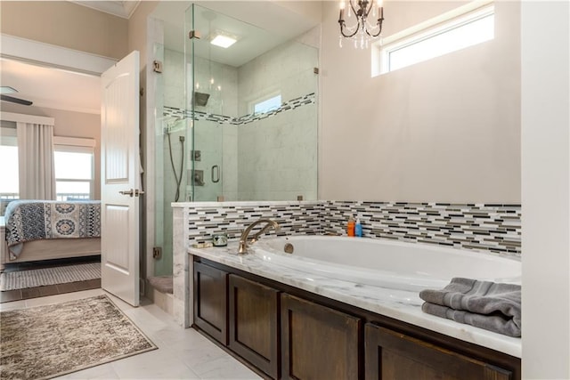 ensuite bathroom with a garden tub, ensuite bath, and a shower stall