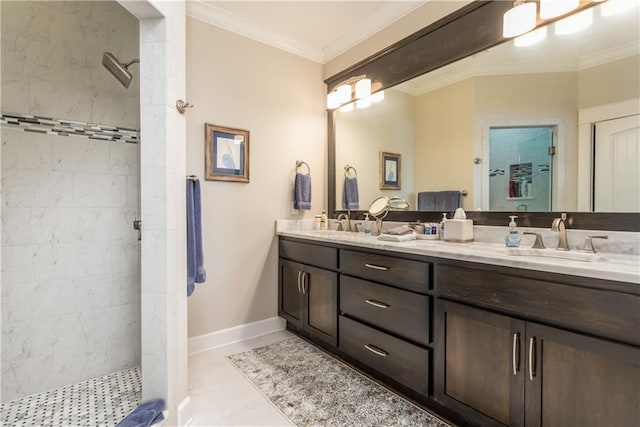 bathroom with double vanity, a stall shower, baseboards, ornamental molding, and a sink