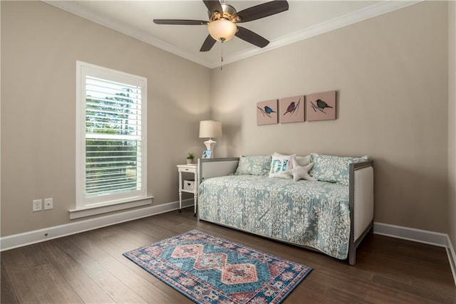 bedroom featuring baseboards, ornamental molding, and wood finished floors