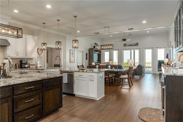 kitchen with dishwasher, a peninsula, dark wood finished floors, and white cabinetry