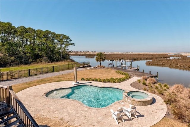 view of pool with a dock, a water view, fence, and a patio