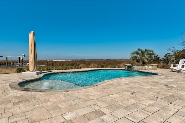 view of swimming pool with a patio area and a pool with connected hot tub