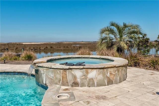 pool with a water view and an in ground hot tub