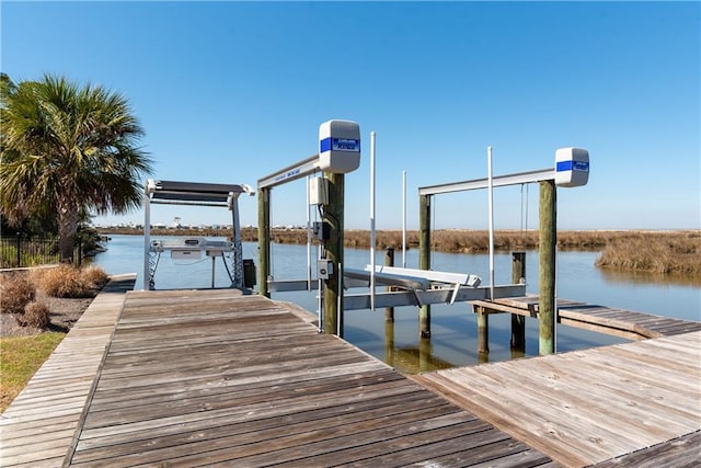 view of dock with a water view and boat lift