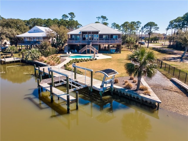 dock area featuring boat lift, a water view, a patio area, fence, and stairs