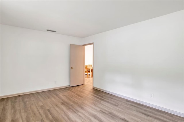 spare room featuring light wood-type flooring