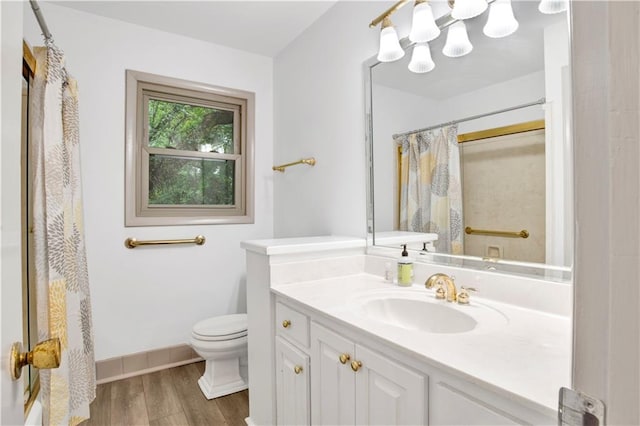 bathroom featuring a shower with shower curtain, vanity, toilet, and wood-type flooring