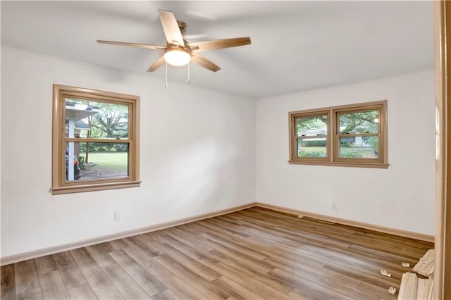 spare room featuring hardwood / wood-style floors and ceiling fan