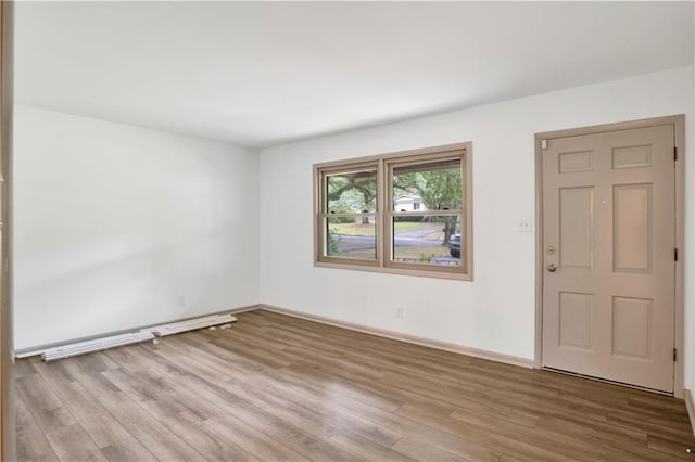 unfurnished room with light wood-type flooring