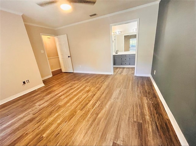 empty room with crown molding, wood-type flooring, and ceiling fan