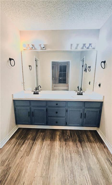 bathroom featuring vanity, a textured ceiling, and wood-type flooring