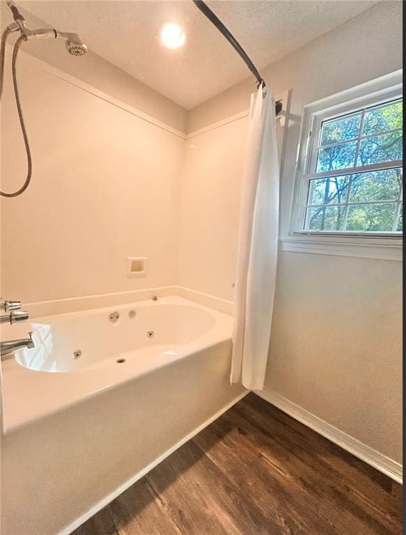 bathroom featuring shower / bath combo with shower curtain and hardwood / wood-style floors