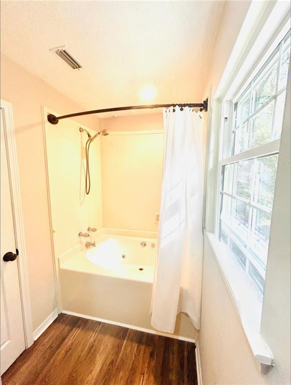 bathroom featuring shower / bath combination with curtain and wood-type flooring