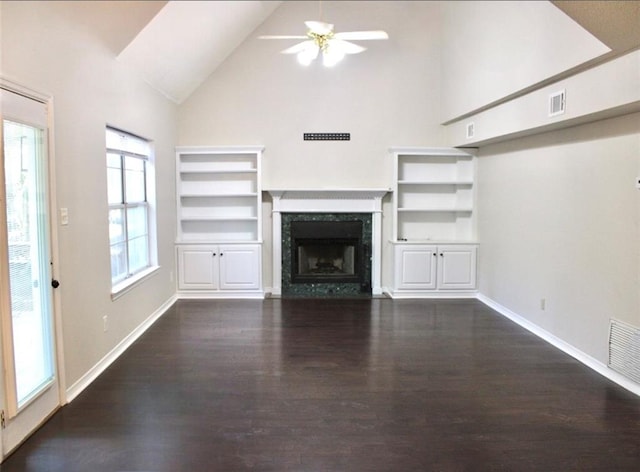 unfurnished living room with ceiling fan, high vaulted ceiling, a premium fireplace, and dark hardwood / wood-style floors