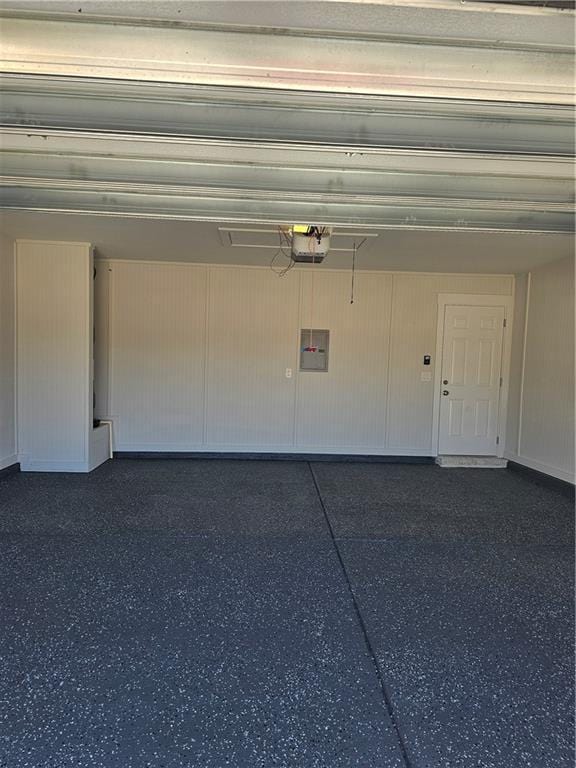 garage featuring a garage door opener and electric panel