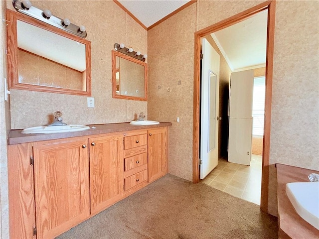 full bathroom with double vanity, a sink, wallpapered walls, and crown molding