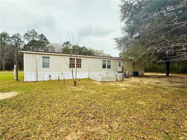 exterior space with entry steps and a lawn