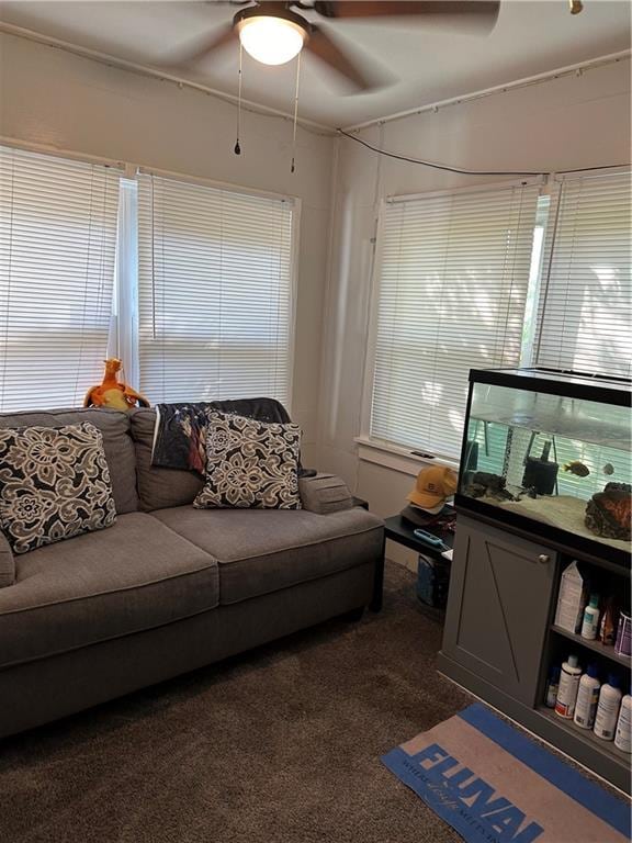 carpeted living room with ceiling fan