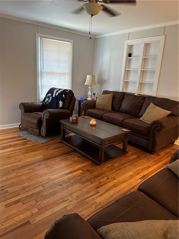 living room featuring ceiling fan, hardwood / wood-style flooring, and ornamental molding