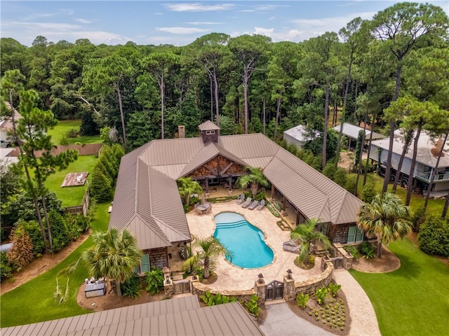 community pool with a patio area and a lawn