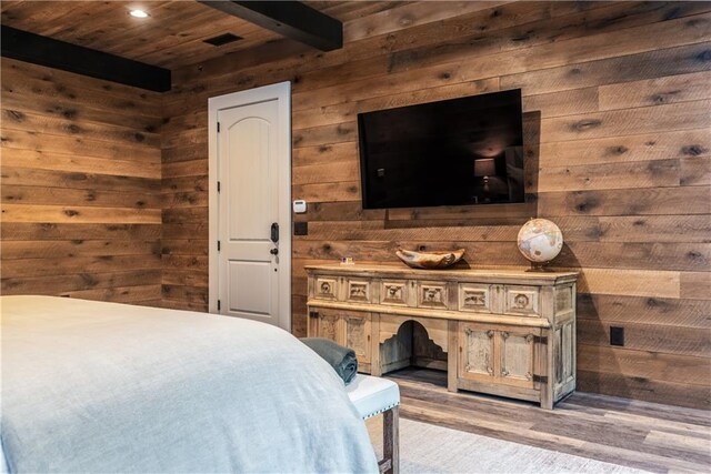 bedroom featuring hardwood / wood-style flooring, wooden walls, and wooden ceiling