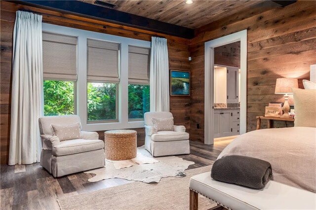 bedroom with wood-type flooring, wooden walls, ensuite bathroom, and wooden ceiling